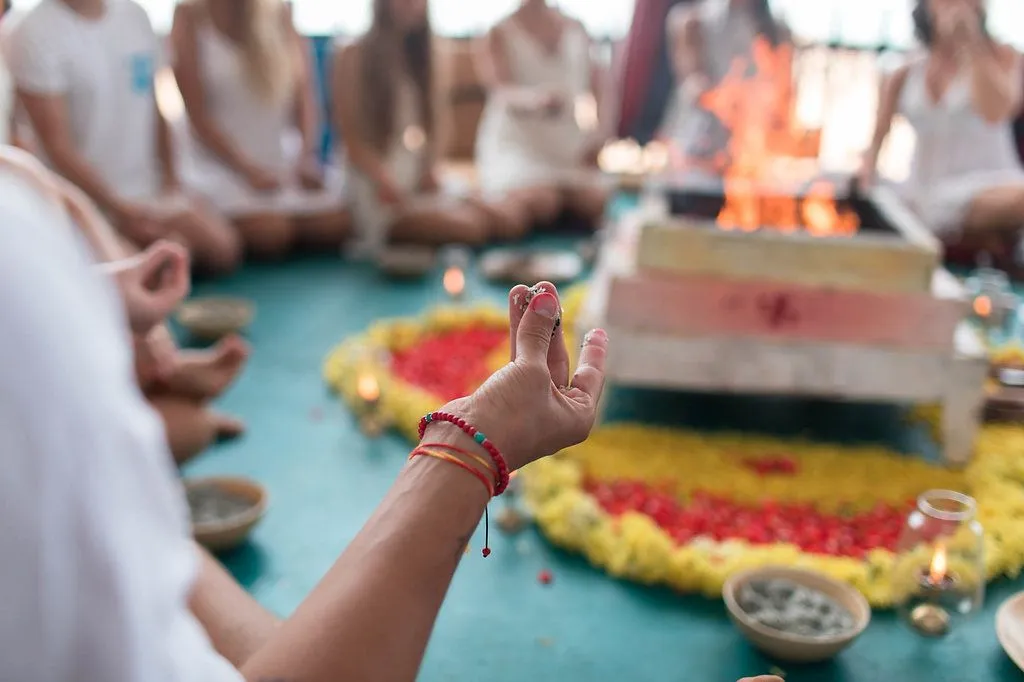 Yoga session on a sandy beach in Goa, India.