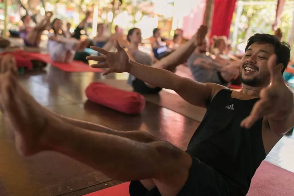 A man practicing yoga with a group of people during a yoga TTC course in Goa.